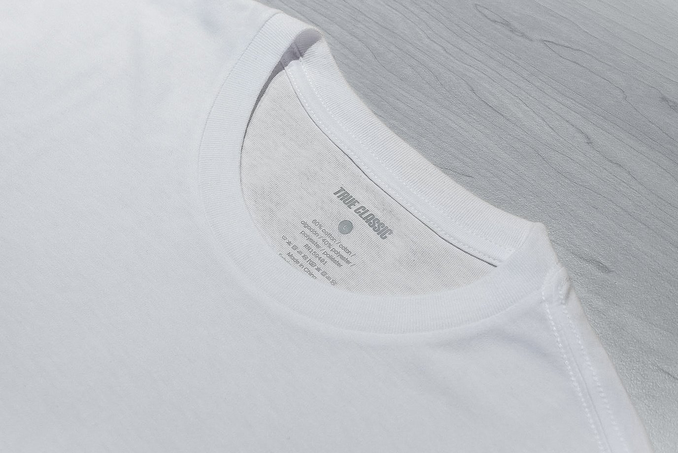 True Classic white tee collar and label close up 