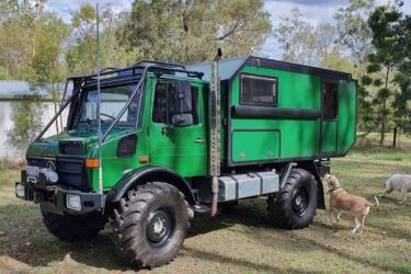 Green Apocalypse Ready Vehicle with camper in Australia.