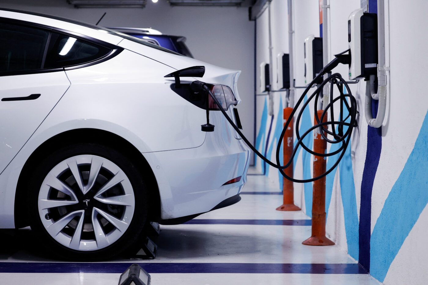 Used electric car charging indoors at station.