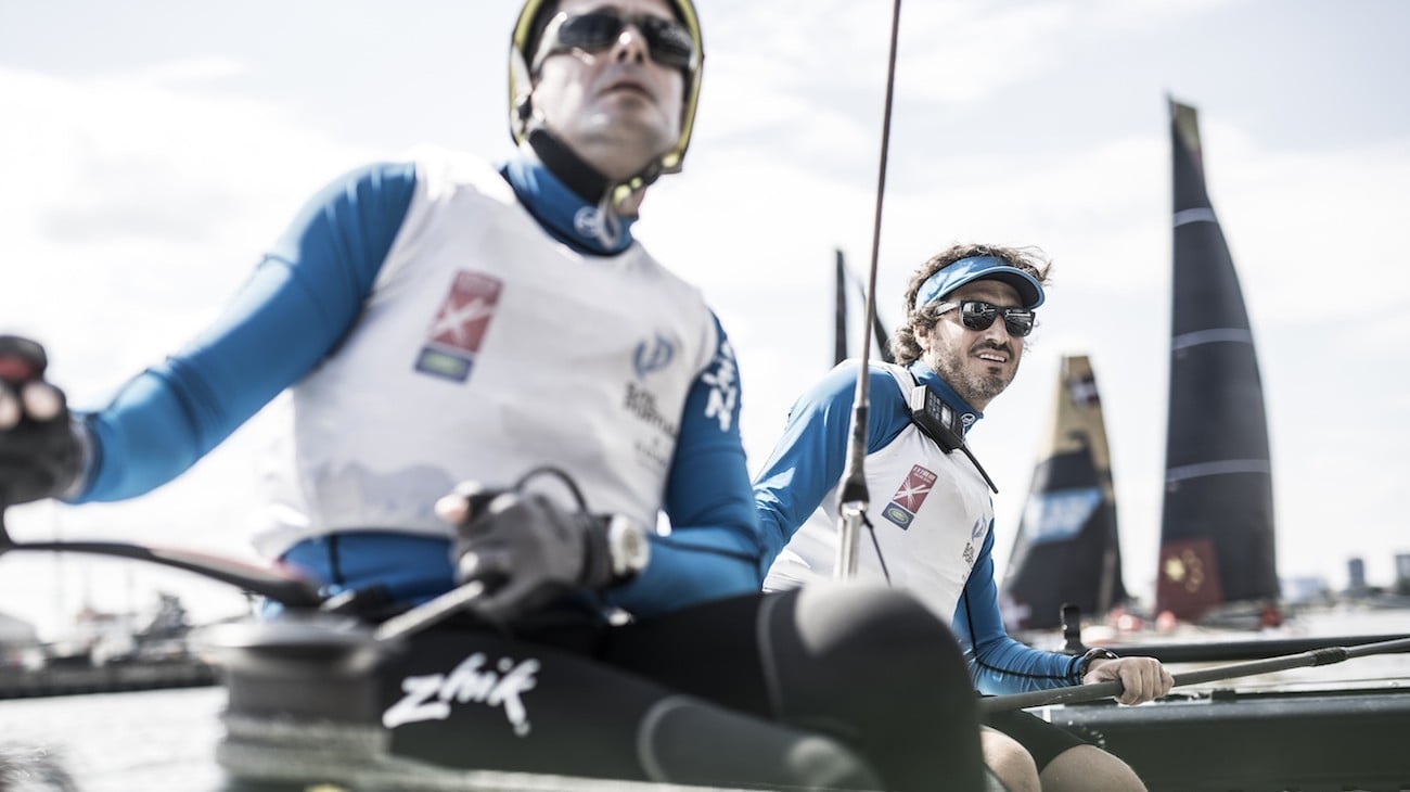 Two sailors in branded gear.