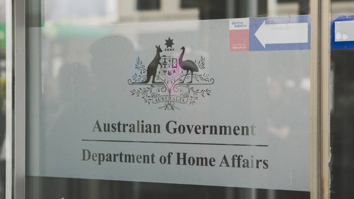 Glass door with Australian Department of Home Affairs logo, 