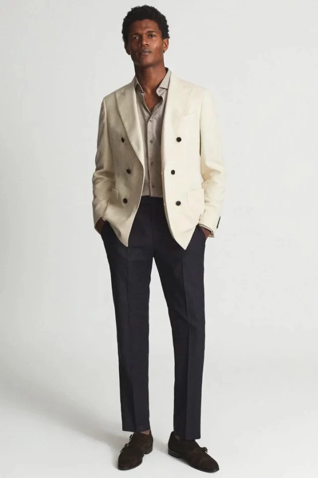 A man wearing white blazer and chino for a business casual attire