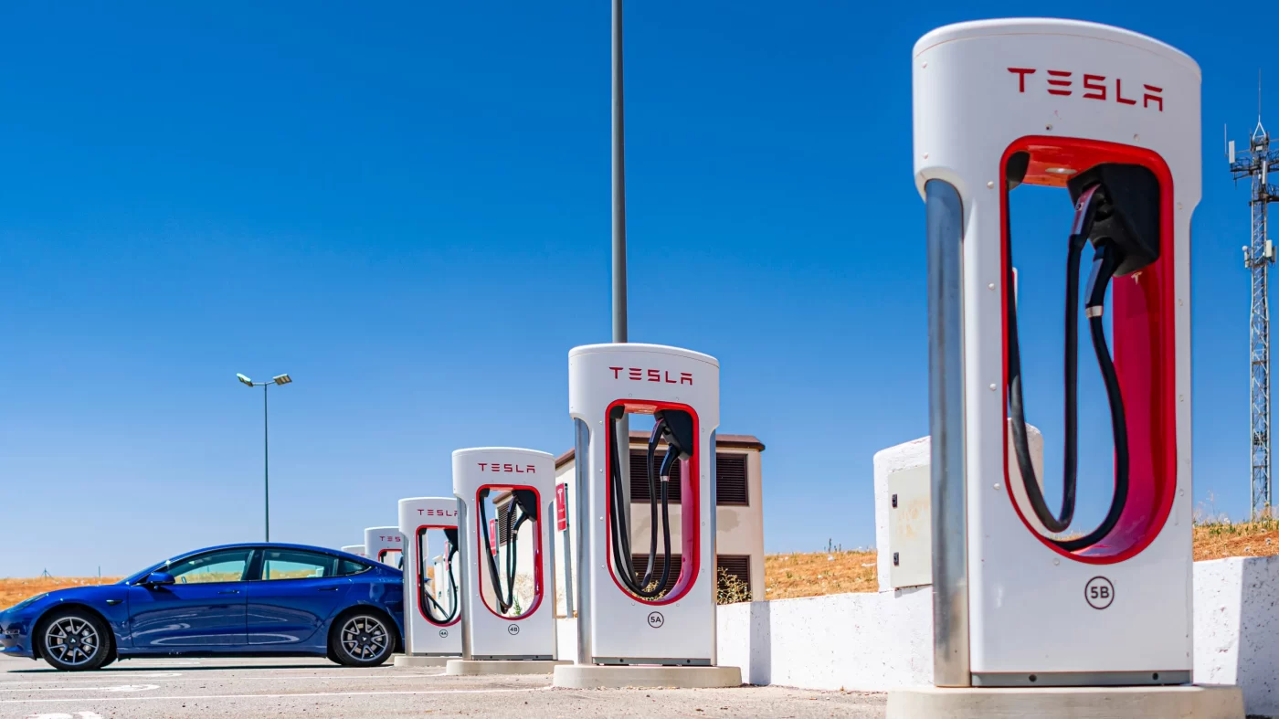 Used blue electric car at Tesla Supercharger.