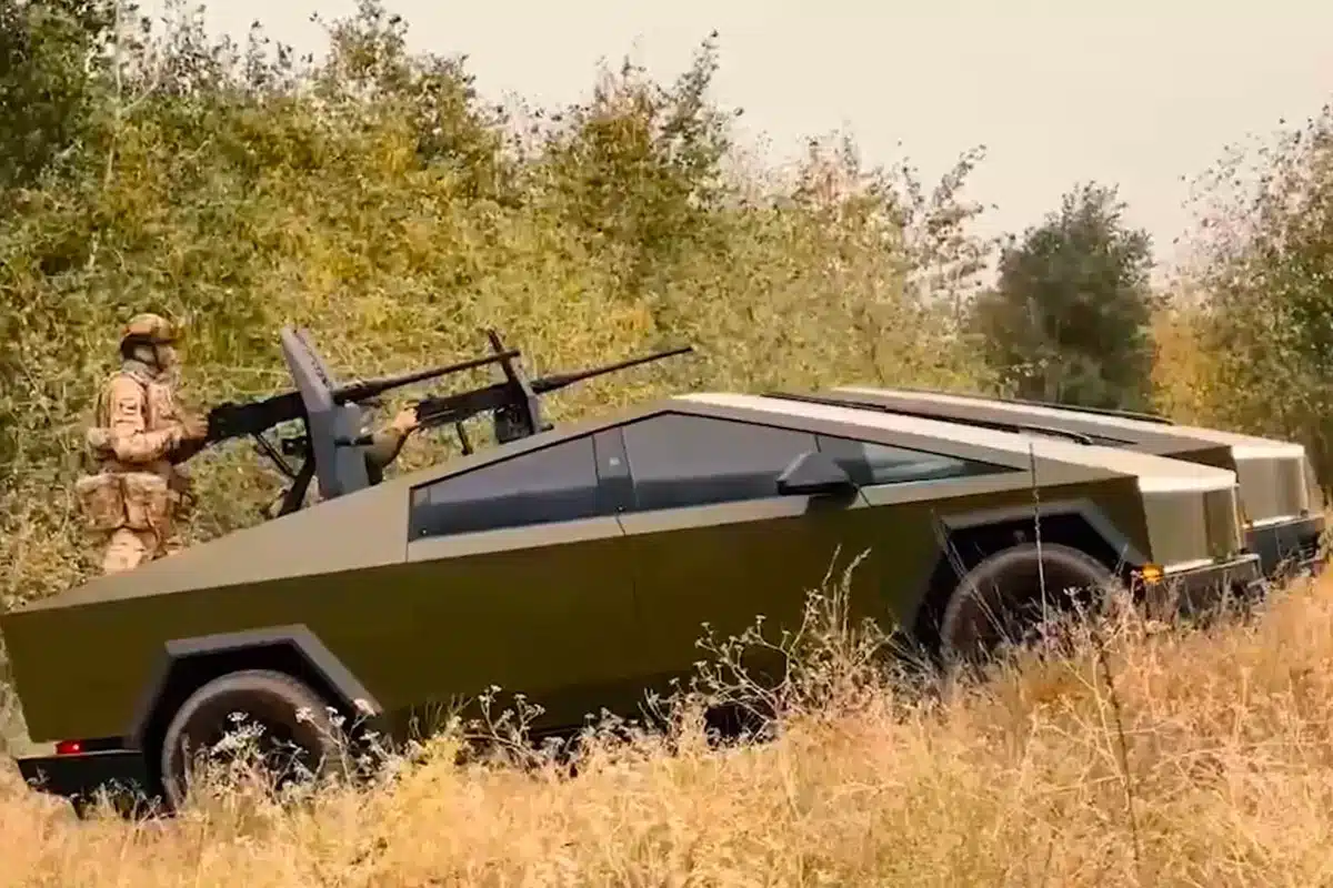 Camouflaged Cybertruck with mounted gun.