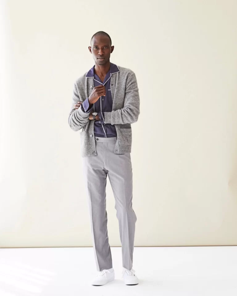 A male model wearing gray cardigan pair with gray trousers for his smart casual attire.